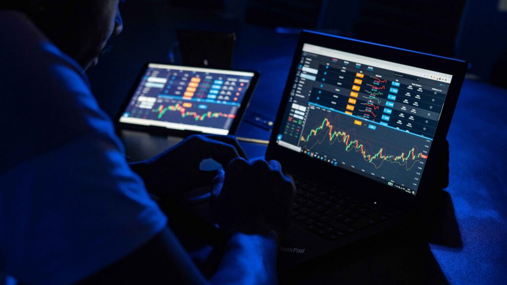 A trader analyzing cryptocurrency charts on multiple screens, displaying price movements and market trends. Ideal for illustrating crypto exchanges in USA.